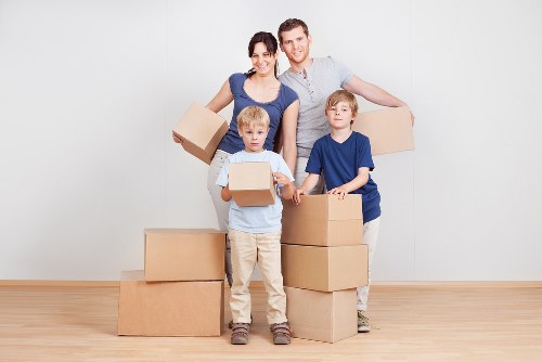 Professional movers handling furniture in an Acton property
