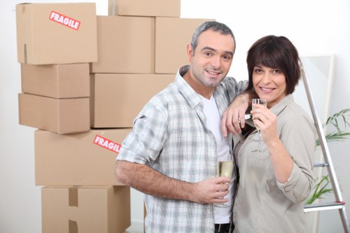 Furniture and boxes being placed into a removals van for an Acton move